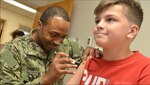 Naval Hospital Corpsman 2nd Class Vernon Thomas, a preventive medicine technician, gives a vaccine to a military family member at Naval Hospital Jacksonville’s Immunizations Clinic, Aug. 8, 2019. (U.S. Navy photo by Petty Officer 1st Class Jacob Sippel)