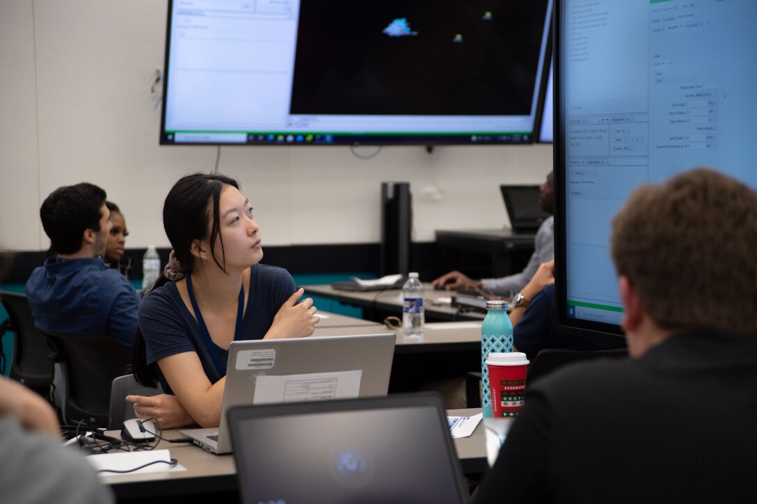 IMAGE: Ellianna Bailey, Naval Surface Warfare Center Dahlgren Division Test Engineer and participant, observes wargaming challenges during the Wargaming Hackathon event at Naval Surface Warfare Center Dahlgren Division, July 27. The bootcamp portion included tutorials on modeling and simulation concepts. The afternoon session included surface warfare scenarios followed by increasingly more difficult scenarios where participants used their acquired M&S skills to defeat the enemy. This event provided an overview of Naval capabilities across all departments.