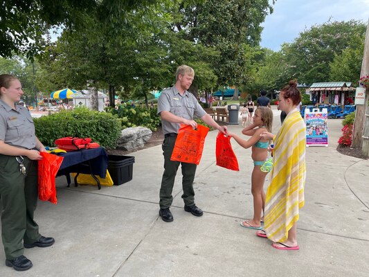 J. Percy Priest Lake park rangers Robin Witt and John Poston handout water safety bags to patrons at Nashville Shores Lakeside Resort to educate the community on the importance of water safety.  (USACE photo by Misty Cunningham)