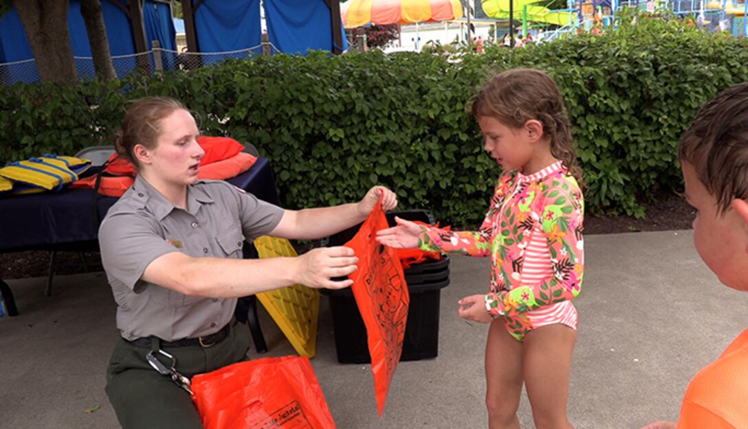 Who wants a water safety goody bag? Children line up for bright bags from the J. Percy Priest Lake park rangers who spread water safety awareness weekly at Nashville Shores Lakeside Resort in an effort to save lives. (USACE photo by Misty Cunningham)