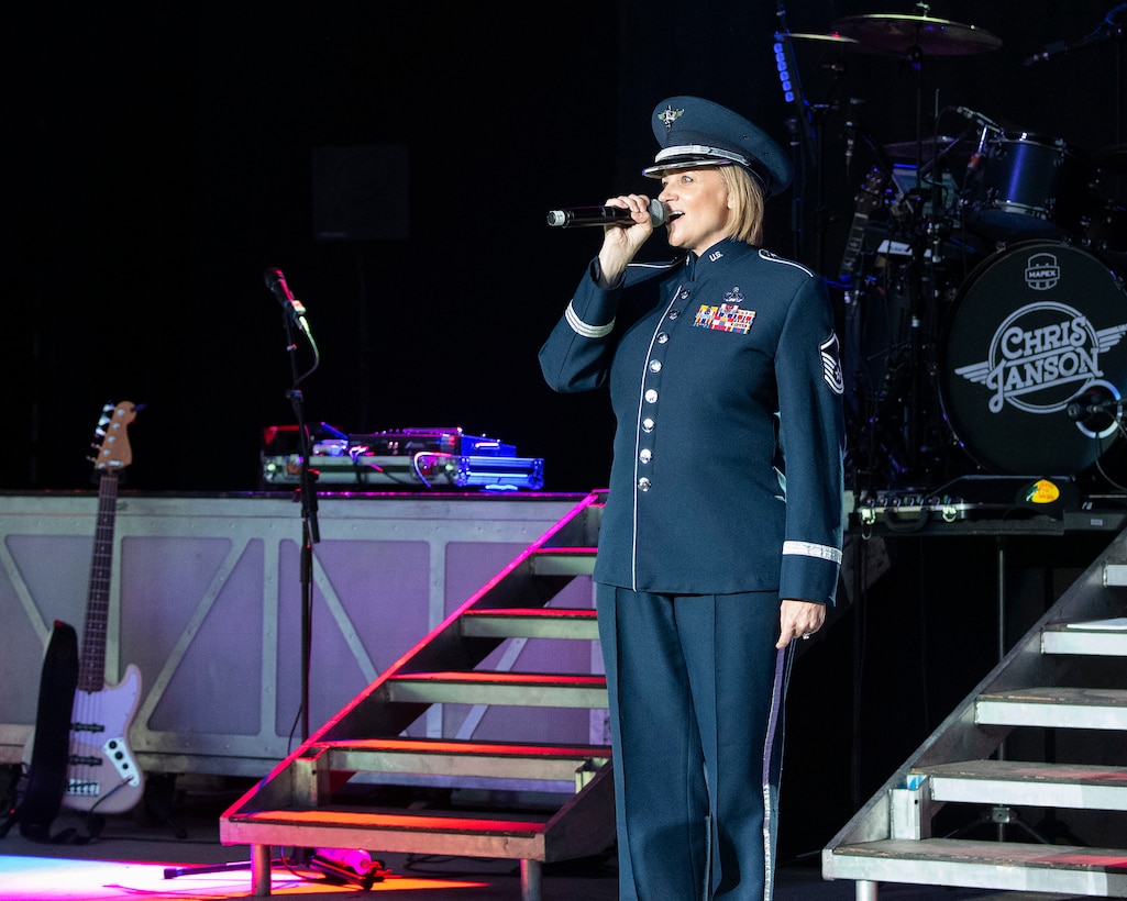 Master Sgt. Christin Foley, U.S. Air Force Band of Flight vocalist, performs the national anthem Aug. 5, 2021, before country star Chris Janson’s concert at Fraze Pavilion in Kettering, Ohio. The concert was part of the Dayton Development Coalition’s Hometown Heroes program. (U.S. Air Force photo by R.J. Oriez)