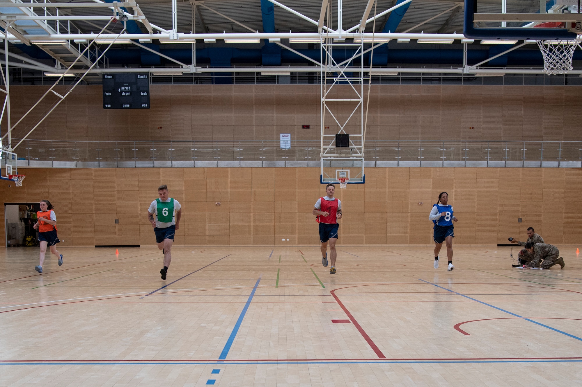 Airmen perform a High Aerobic Multi-shuttle Run during a mock physical training test, Aug. 3, 2021. The shuttle run is one of three options available for Air Force members to choose from as part of the alternative assessments for the run portion of their fitness assessments.