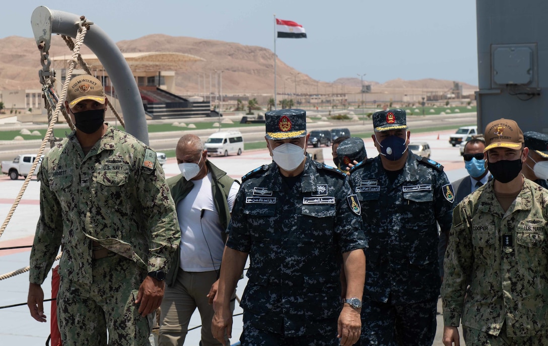 BERENICE, Egypt (August 12, 2021) – Capt. Joseph Baggett, commanding officer of guided-missile cruiser USS Monterey (CG 61), left, Vice Adm. Ahmed Khaled Hassan Saeed, commander of the Egyptian Naval Force, center, and Vice Adm. Brad Cooper, commander of U.S. Naval Forces Central Command (NAVCENT), U.S. 5th Fleet and Combined Maritime Forces (CMF), far right, walk together during a tour of the ship in Berenice, Egypt, Aug. 12. Monterey is deployed to the U.S. 5th Fleet area of operations in support of naval operations to ensure maritime stability and security in the Central Region, connecting the Mediterranean and Pacific through the western Indian Ocean and three strategic choke points. (U.S. Navy photo by Mass Communication Specialist Seaman Chelsea Palmer)