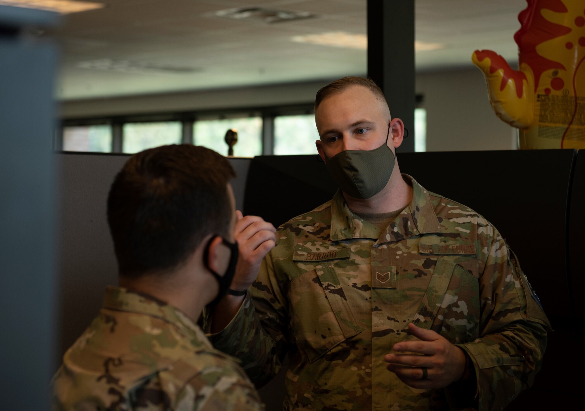 SSgt. Selby Barron gives Col. David Wilson a prebrief of the days events, while standing in the 21st contracting squadron