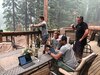 Members of the Pennsylvania Air National Guard are serving as imagery experts, providing live aerial video streaming to fire bosses working on the front lines of the devastating fires. Here they gather fire perimeter information from the RC26 on the DIXIE FIRE in Chester, Calif. July 25. Shown are: Senior Airman Julius Reed, Pennsylvania Air National Guard (front seated); Staff Sgt. William Gray, Pennsylvania Air National Guard (rear seated), Senior Airman Jesse Mauricio Oklahoma Air National Guard (standing by railing) and Mr. Joel Kerley (standing right), National Interagency Fire Center.