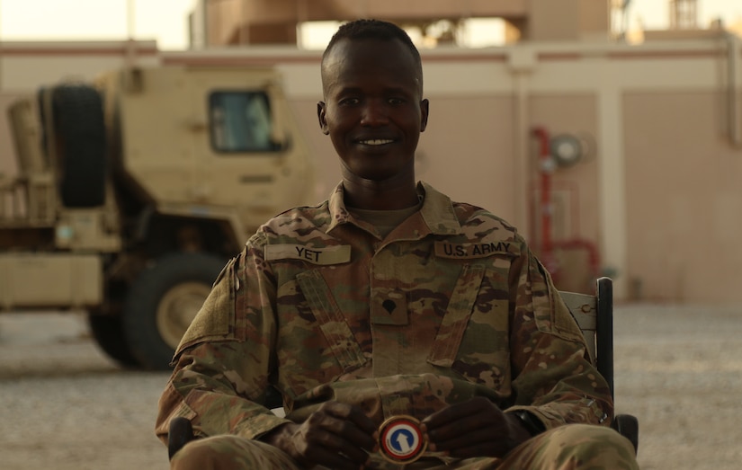 Unit Supply Specialist Spc. Fourtytwo Yet, an Iowa National Guardsman assigned to the 3654th Support Maintenance Company, was awarded a unit coin by the commanding general of the 1st Theater Sustainment Command, Maj. Gen. Michel M. Russell Sr., during a battlefield circulation, July 26, 2021. Yet was awarded the coin by the general for the excellence and proficiency he displayed during the commander’s walk through. (U.S. Army Photo by Sgt. Marquis Hopkins)