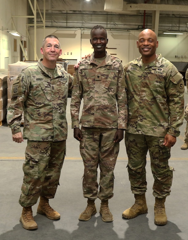 Maj. Gen. Michel M. Russell Sr., the commanding general of the 1st Theater Sustainment Command, and Command Sgt. Maj. Michael J. Perry III, the senior enlisted advisor of the 1st TSC, get to know Spc. Fourtytwo Yet, an Iowa National Guard supply specialist, assigned to 3654th Support Maintenance Company during a battlefield circulation July 26, 2021. Yet was awarded a unit coin by the general for the excellence and proficiency he displayed during the commander’s walk through. (U.S. Army Photo by Sgt. Marquis Hopkins)