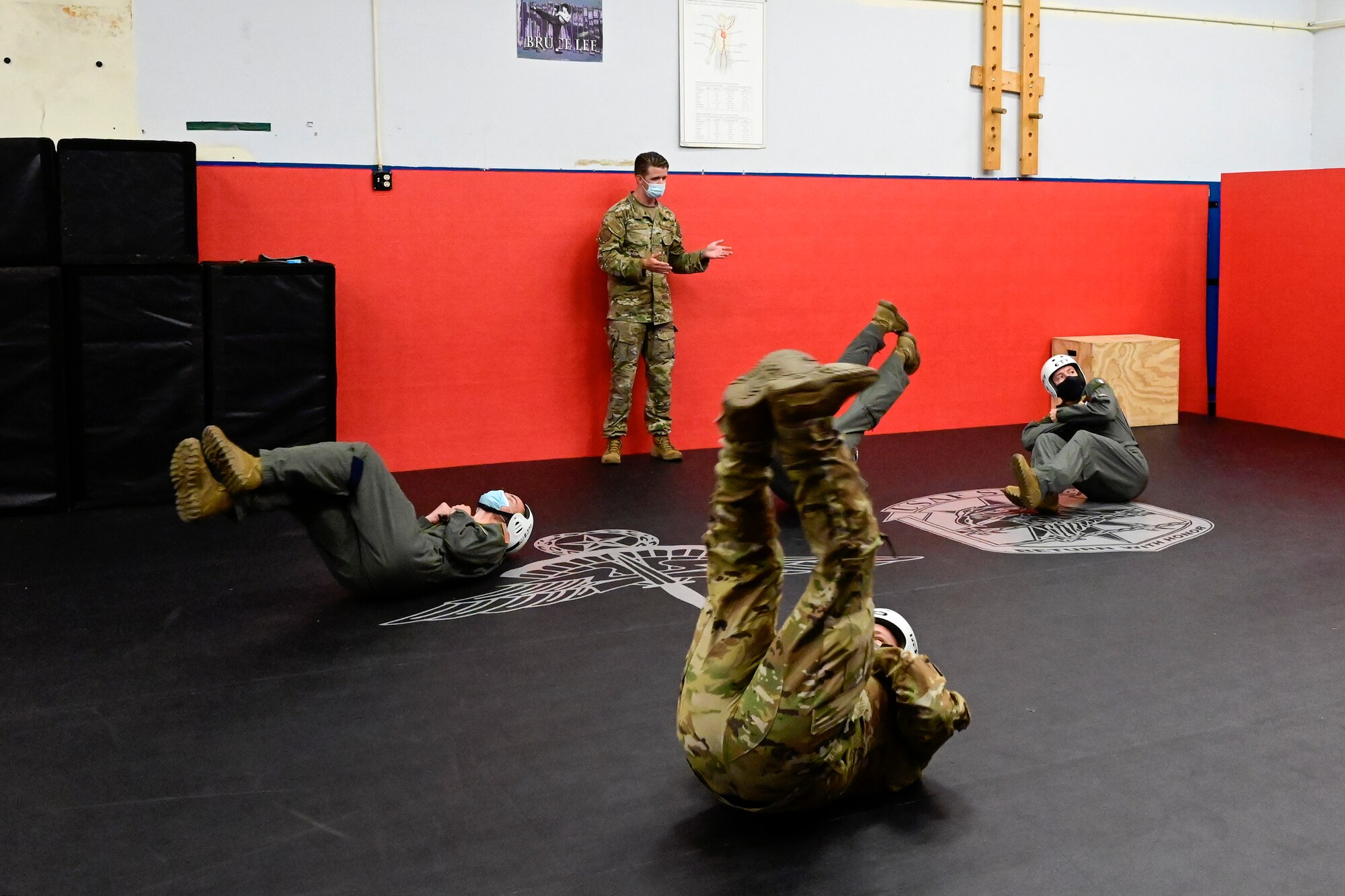An instructor directs students during jump training.