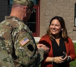 Maj. Gen. Greg Knight, Vermont's adjutant general, presents Dr. Maria Mercedes Avila with a coin during a workshop on structural competence and cultural humility at Vermont Air National Guard Base in South Burlington, Vermont, Aug. 13, 2021. Avila is a member of the Vermont Governor's Workforce Equity and Diversity Council and is working with the Vermont National Guard's Joint Diversity Executive Council to improve inclusiveness within the Guard. (U.S. Army National Guard photo by Don Branum)