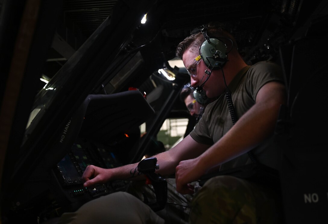 U.S. Air Force Airmen, assigned to the 362nd Training Squadron, Detachment One, check the different mechanisms on a Sikorsky UH-60 Black Hawk helicopter, simulator at Joint Base Langley-Eustis, Virginia, July 16, 2021. The instructors introduce new objectives and techniques throughout the course to help keep the students focused and excited about learning. (U.S. Air Force photo by Senior Airman Sarah Dowe)