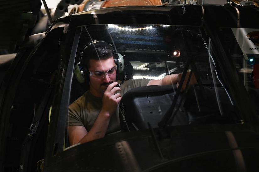 A U.S. Air Force Airman, assigned to the 362nd Training Squadron, Detachment One, talks through a headset while conducting helicopter maintenance on a Sikorsky UH-60 Black Hawk helicopter, simulator at Joint Base Langley-Eustis, Virginia, July 16, 2021. The students communicate with each other and with instructors just as they would in a working environment to help simulate real-life scenarios. (U.S. Air Force photo by Senior Airman Sarah Dowe)