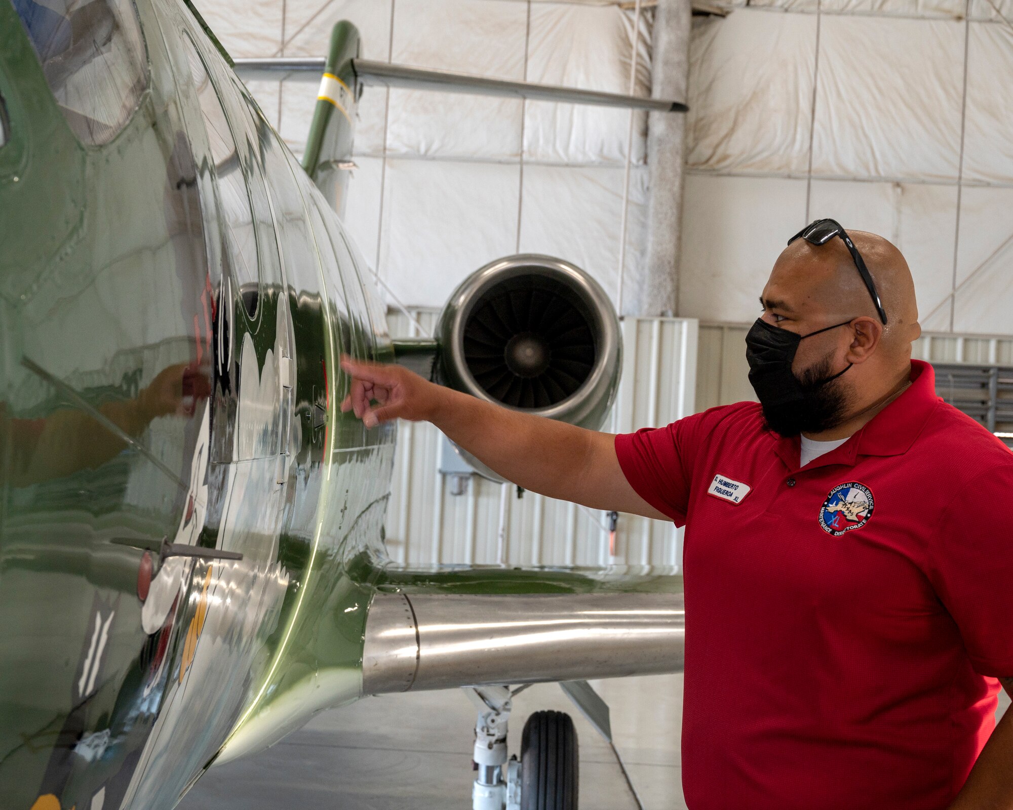 Humberto Figueroa, 47th Flying Training Wing aircraft maintainer, traces the art of the new heritage tail of the 86th Flying Training Squadron at Laughlin Air Force Base, Texas, on August 13, 2021. The paint scheme of the aircraft reaches back to the Douglas B-18 “Bolo” of World War II and honors the Airmen who served aboard, the nose of the aircraft is also inscribed with Capt. Glen Edward’s name in memory of his service to the U.S. Air Force. (U.S. Air Force Photo by Senior Airman Nicholas Larsen)