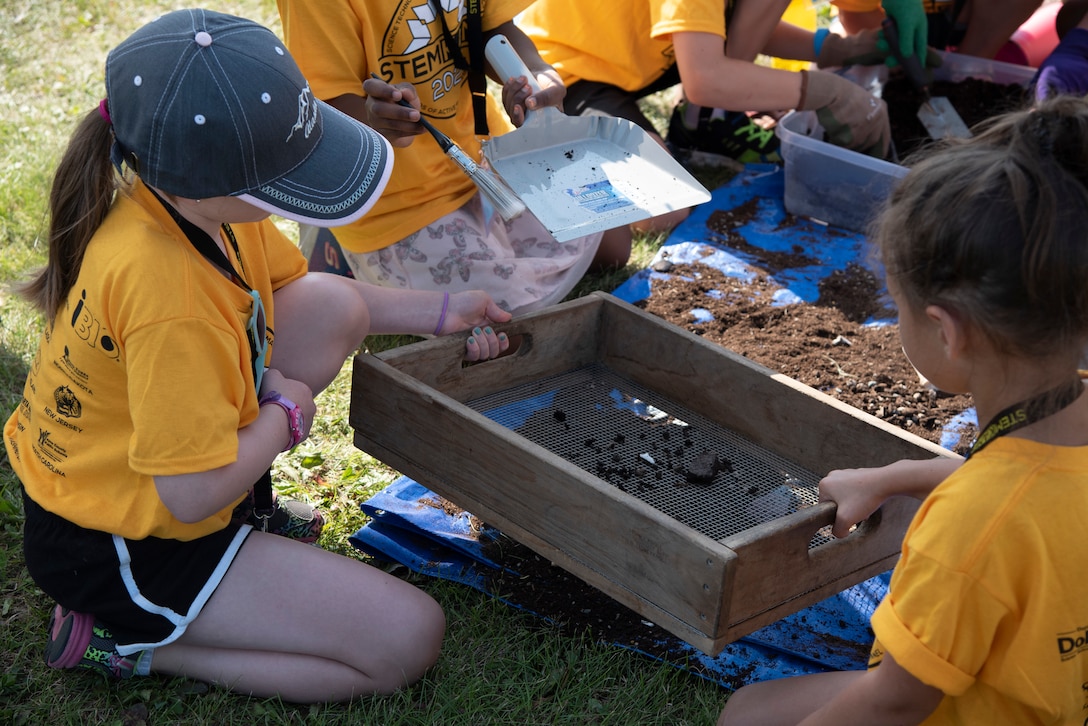 Students work together to sift soil during an archeology demonstration on Aug. 5 at the Chena River Lakes Flood Control Project near North Pole, Alaska.