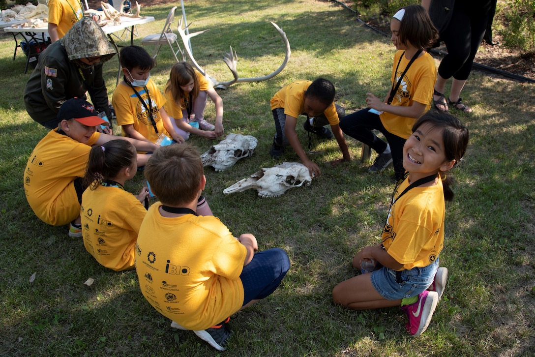 Campers examine moose skulls with Ranna Wells, zooarcheologist with the U.S. Army Corps of Engineers – Alaska District, on Aug. 5 at the Chena River Lakes Flood Control Project near North Pole, Alaska.