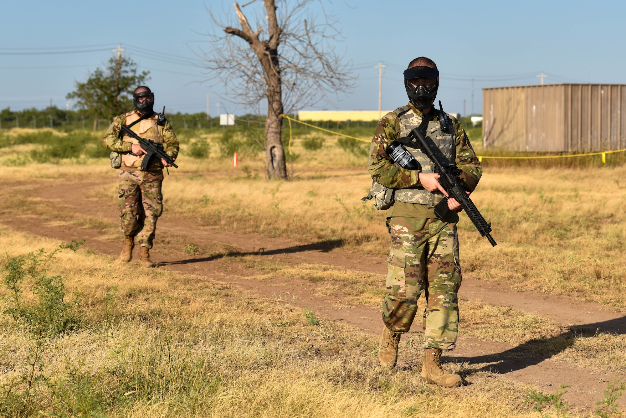 U.S. Air Force Tech. Sgt. Mike Lowry, 315th Training Squadron instructor, and Tech. Sgt. Steven Boyd, 315th TRS instructor, perform a perimeter check during the Expeditionary Readiness Training exercise on Goodfellow Air Force Base, Aug. 13, 2021. During the exercise, ERT members assess simulated threats in the area. (U.S. Air Force photo by Senior Airman Jermaine Ayers)