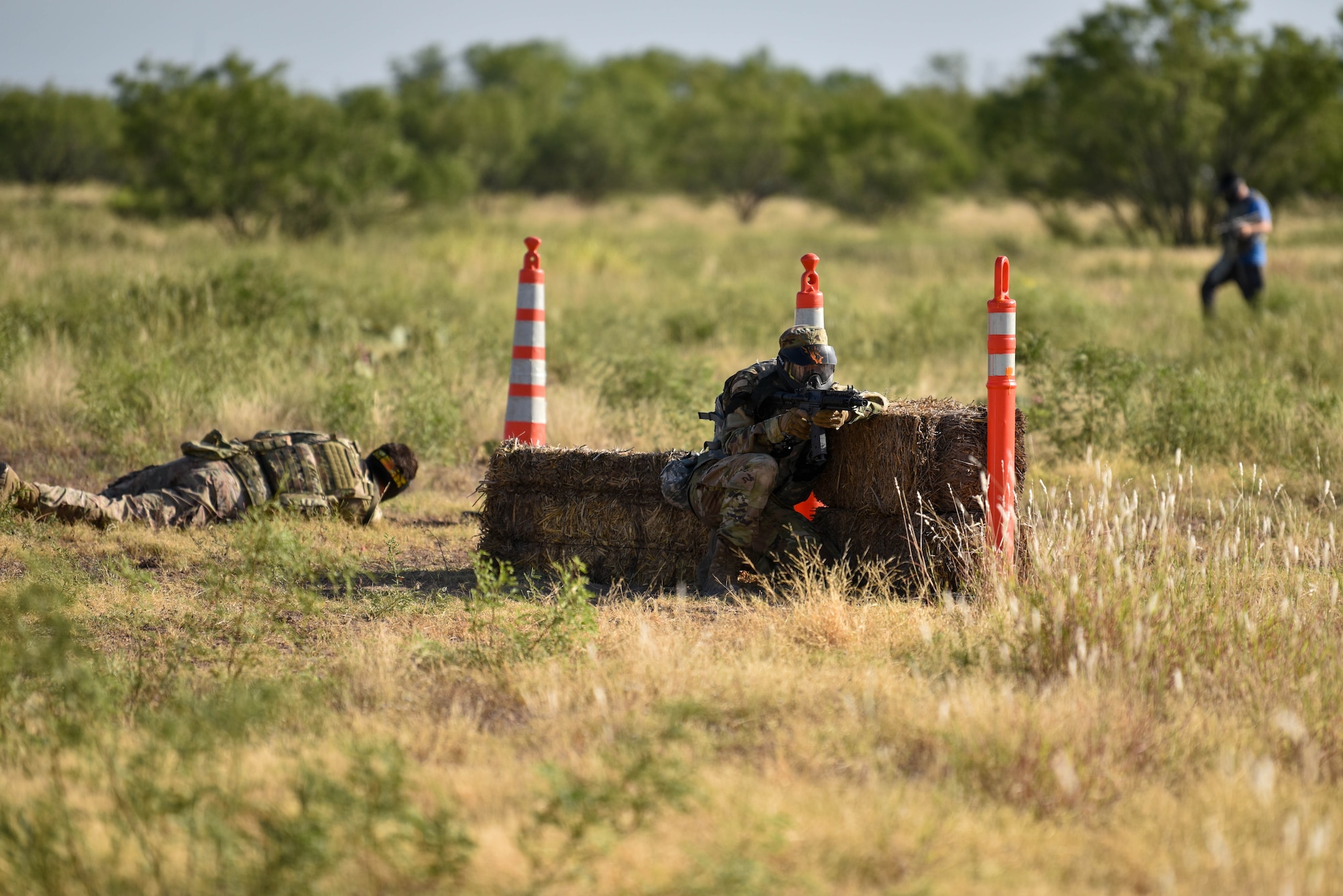 U.S. Air Force 17th Training Wing members shoot paintballs at opposition forces during the Expeditionary Readiness Training exercise on Goodfellow Air Force Base, Aug. 13, 2021. Throughout the week, members trained and developed essential expeditionary skills to build a lethal and ready force. (U.S. Air Force photo by Senior Airman Jermaine Ayers)