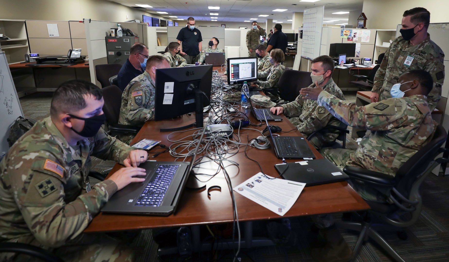 Augmentees from various Army commands collaborate in the joint operations center at Joint Task Force Civil Support headquarters