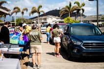 U.S. Marines volunteer to hand out backpacks filled with school supplies to local families, Marine Corps Base Hawaii, Aug. 7, 2021. Marine Corps Community Services partnered with Operation Homefront and the Single Marine and Sailor Program to conduct the school supply giveaway for two-hundred children on MCBH. (U.S. Marine Corps photo by Lance Cpl. Brandon Aultman)