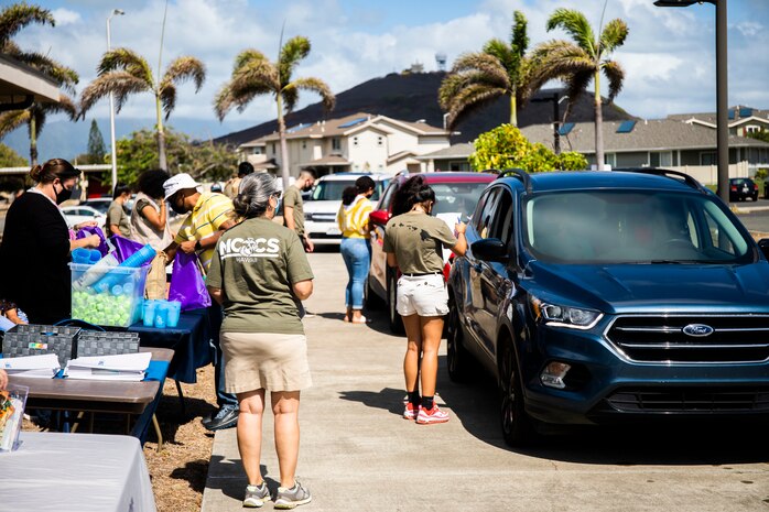 U.S. Marines volunteer to hand out backpacks filled with school supplies to local families, Marine Corps Base Hawaii, Aug. 7, 2021. Marine Corps Community Services partnered with Operation Homefront and the Single Marine and Sailor Program to conduct the school supply giveaway for two-hundred children on MCBH. (U.S. Marine Corps photo by Lance Cpl. Brandon Aultman)