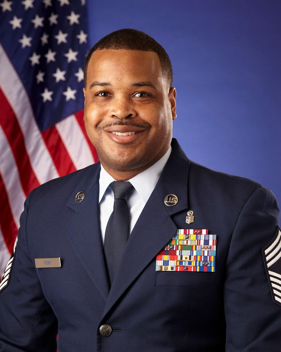 Man in military uniform smiling.