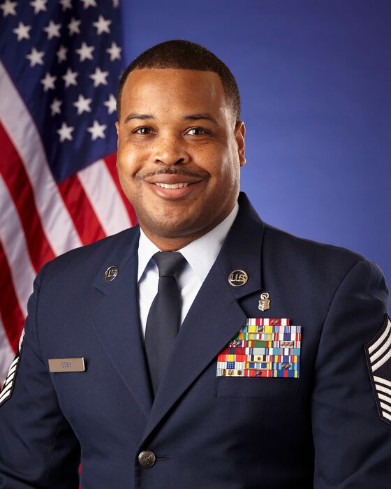 Man in military uniform smiling.