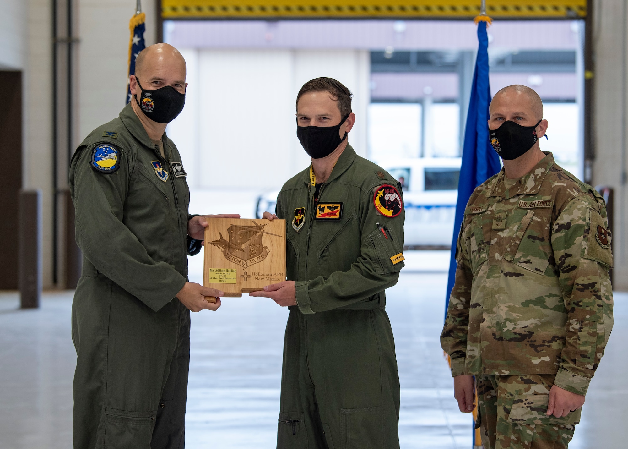 Maj. Addison Harding, quarterly award winner, accepts the Field Grade Officer of the quarter award during the 49th Wing’s 2nd quarter award ceremony, Aug. 13, 2021, on Holloman Air Force Base, New Mexico. Quarterly award winners were selected based on their technical expertise, demonstration of leadership and job performance. (U.S. Air Force photo by Airman 1st Class Jessica Sanchez)