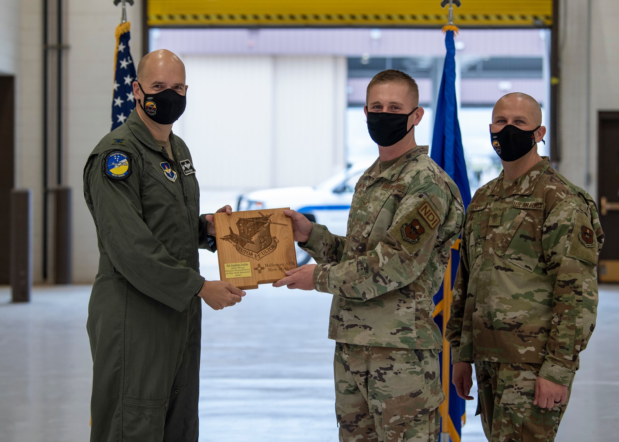 Senior Airman Jonathan Jenkins, quarterly award winner, accepts the Honor Guardsman of the quarter award during the 49th Wing’s 2nd quarter award ceremony, Aug. 13, 2021, on Holloman Air Force Base, New Mexico. Quarterly award winners were selected based on their technical expertise, demonstration of leadership and job performance. (U.S. Air Force photo by Airman 1st Class Jessica Sanchez)