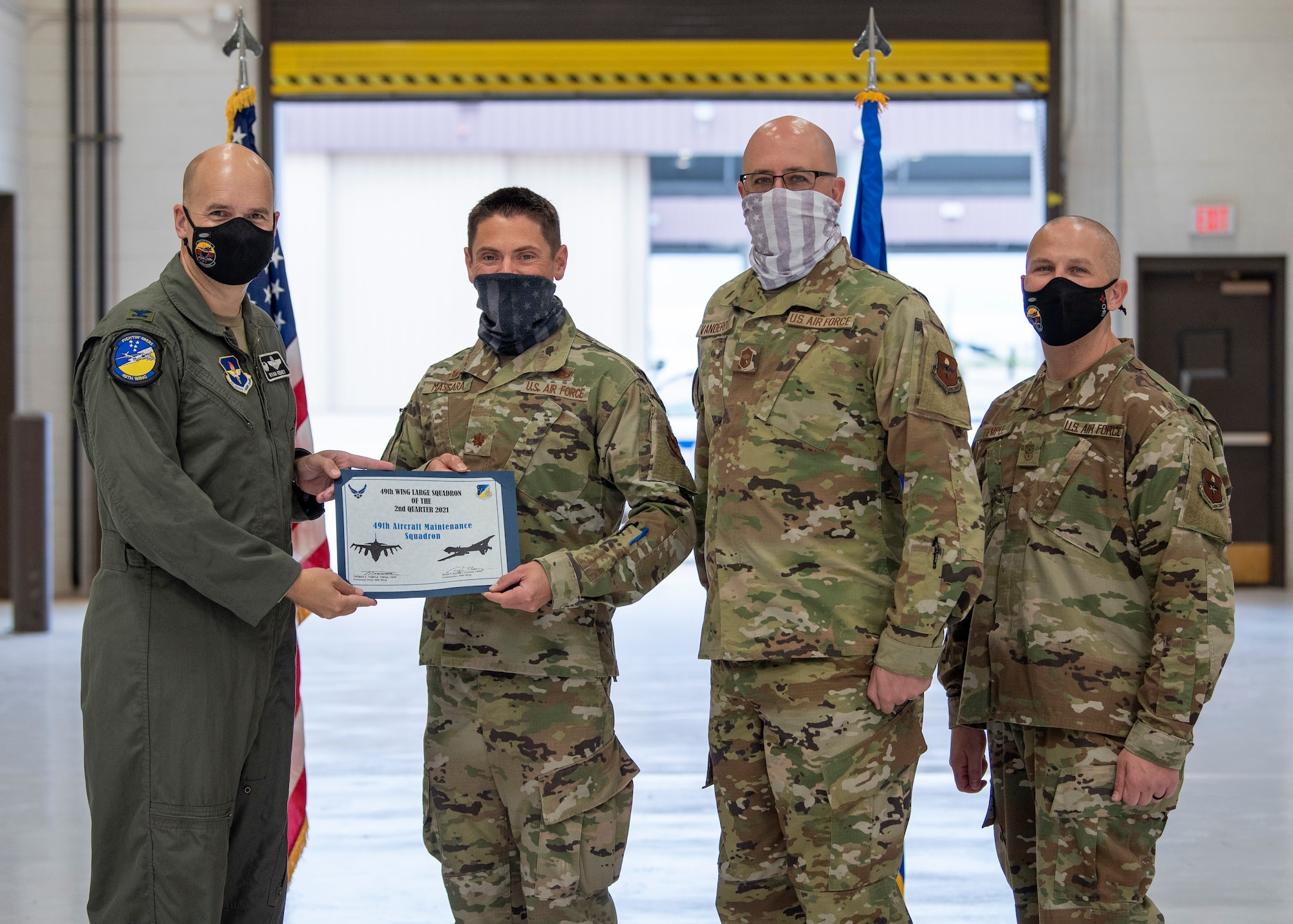 Representatives accept the Large Unit of the quarter award on behalf of the 49th Aircraft Maintenance Squadron during the 49th Wing’s 2nd quarter award ceremony, Aug. 13, 2021, on Holloman Air Force Base, New Mexico. Quarterly award winners were selected based on their technical expertise, demonstration of leadership and job performance. (U.S. Air Force photo by Airman 1st Class Jessica Sanchez)