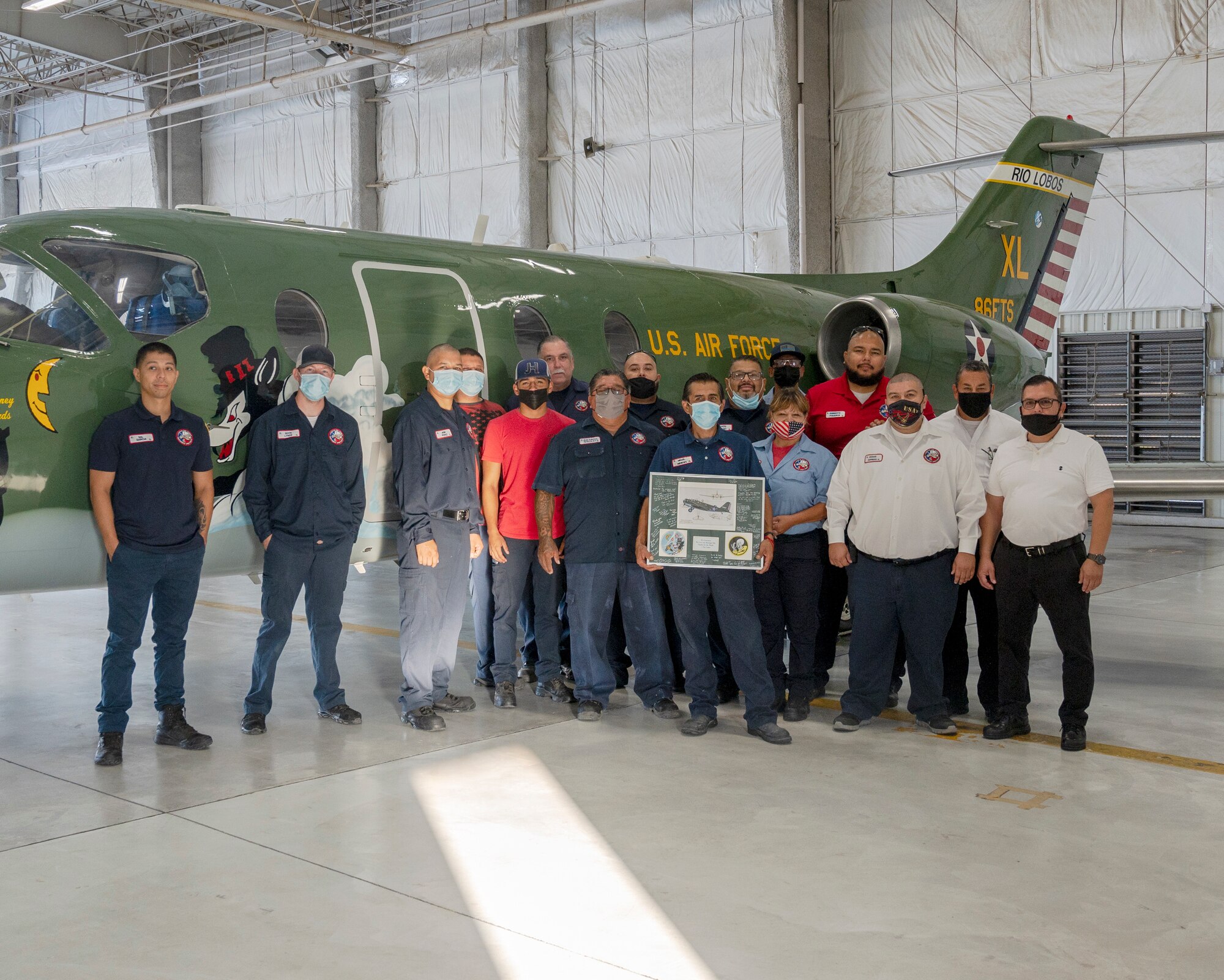Aircraft maintainers from Laughlin Air Force Base, Texas, pose with the plaque given to them for their work with the heritage tail on August 13, 2021. The paint scheme of the aircraft reaches back to the Douglas B-18 “Bolo” of World War II and honors the Airmen who served aboard, the nose of the aircraft is also inscribed with Capt. Glen Edward’s name in memory of his service to the U.S. Air Force. (U.S. Air Force Photo by Senior Airman Nicholas Larsen)
