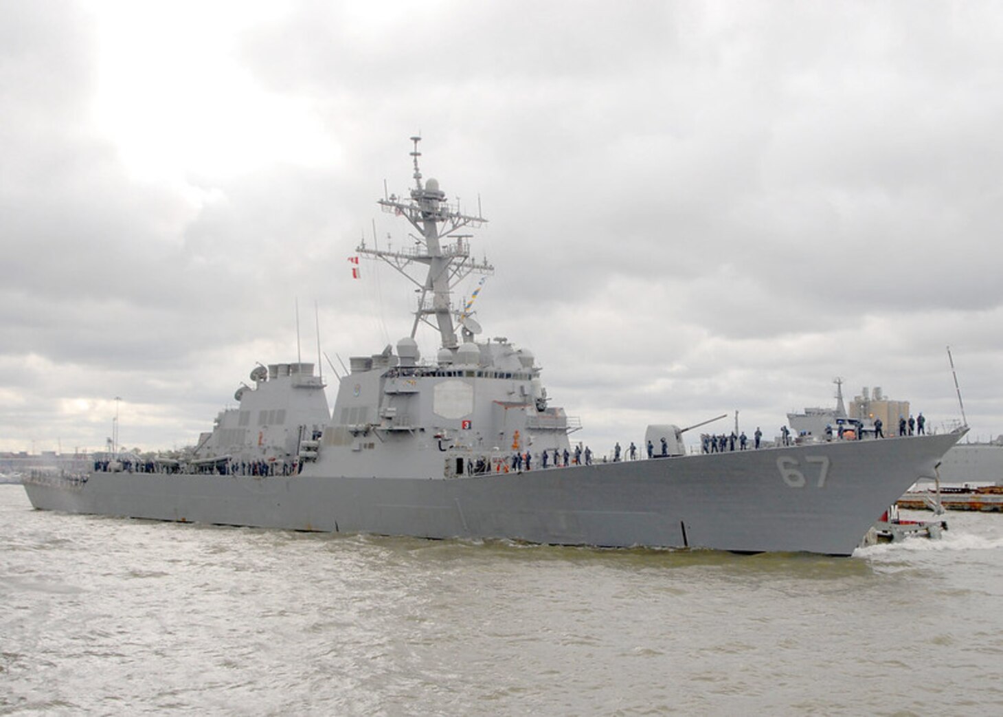 Sailors aboard the guided-missile destroyer USS Cole (DDG 67) heave in mooring lines as the ship departs Naval Station Norfolk. Cole is headed to the U.S. 6th Fleet area of responsibility for a routine deployment focused on ballistic missile defense.