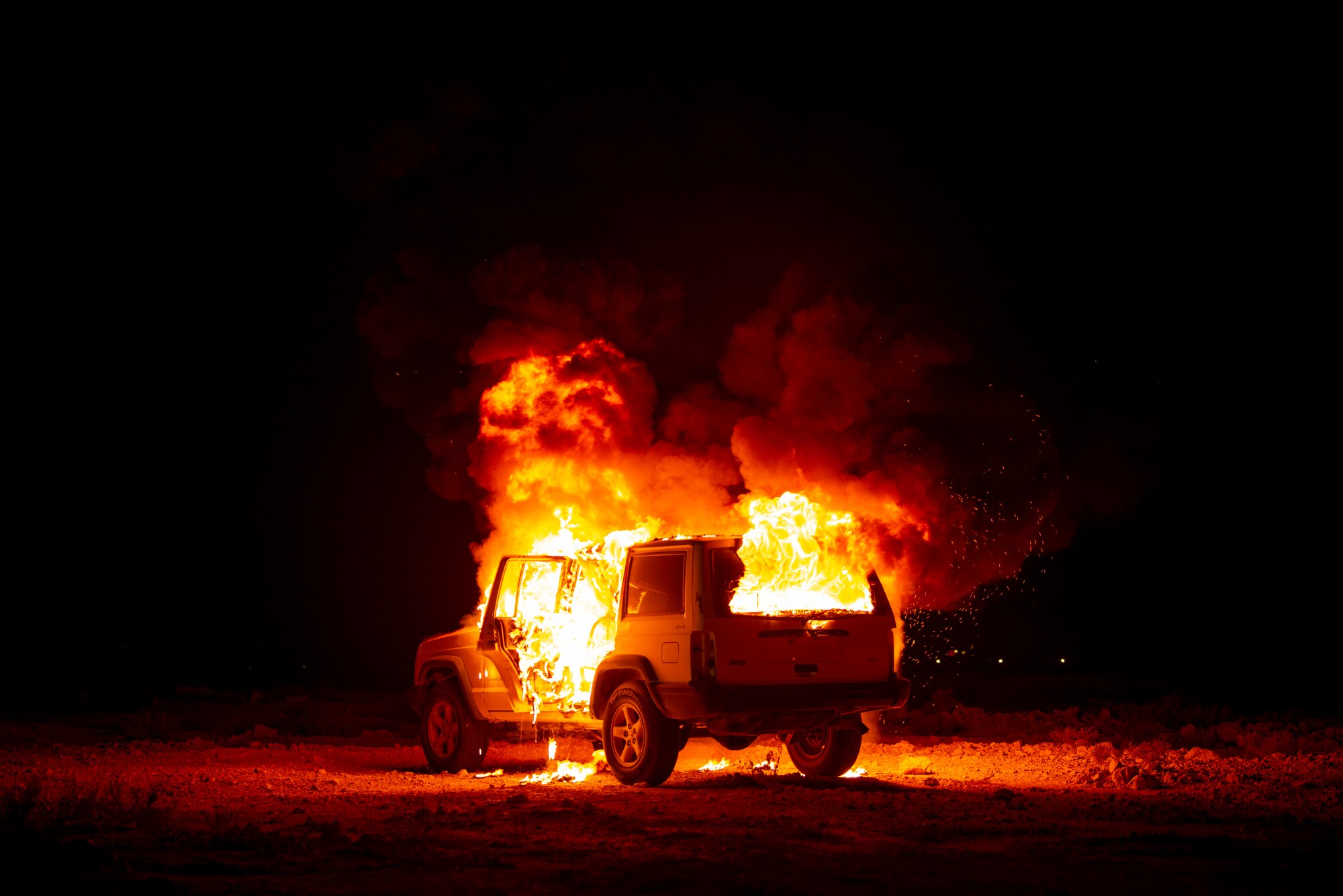 A vehicle burns during a firefighting training exercise August 10, 2021, at Al Udeid Air Base, Qatar.
