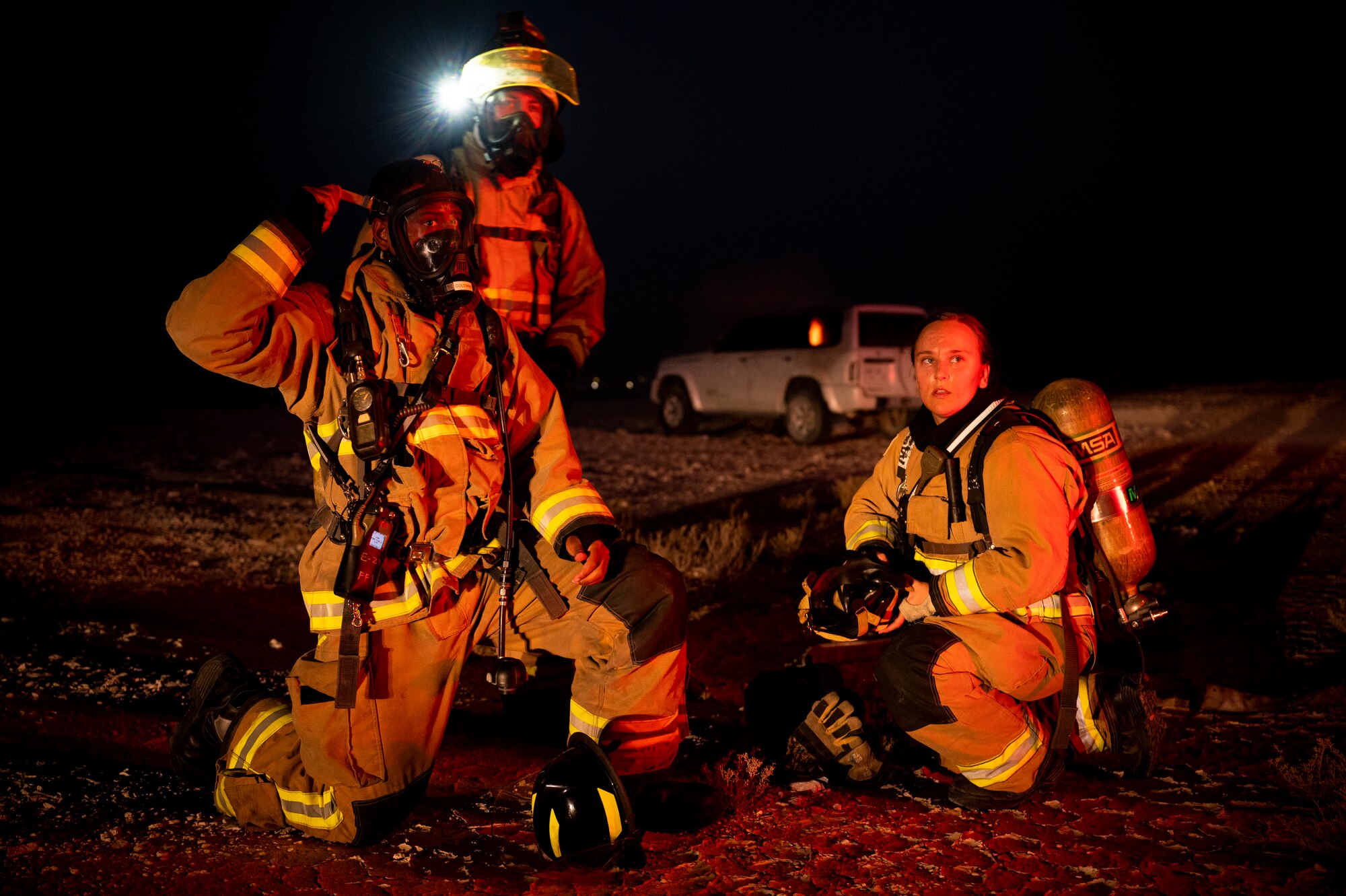 379th Expeditionary Civil Engineer Squadron firefighters don protective gear during a training exercise August 10, 2021, at Al Udeid Air Base, Qatar.