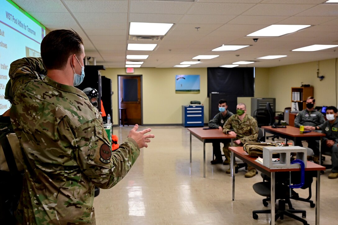 An instructor leads a class as students listen in.