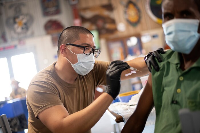 A hospital corpsman administers a vaccination.