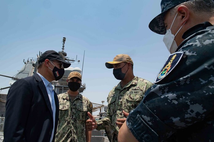 210812-N-WQ732-1027 BERENICE, Egypt (August 12, 2021) – U.S. Ambassador to Egypt, Jonathan Cohen, left, speaks with Capt. Joseph Baggett, commanding officer of guided-missile cruiser USS Monterey (CG 61) during a tour of the ship in Berenice, Egypt, Aug. 12. Monterey is deployed to the U.S. 5th Fleet area of operations in support of naval operations to ensure maritime stability and security in the Central Region, connecting the Mediterranean and Pacific through the western Indian Ocean and three strategic choke points. (U.S. Navy photo by Mass Communication Specialist Seaman Chelsea Palmer)