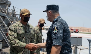 210812-N-WQ732-1016 BERENICE, Egypt (August 12, 2021) – Capt. Joseph Baggett, commanding officer of guided-missile cruiser USS Monterey (CG 61), left, greets Vice Adm. Ahmed Khaled Hassan Saeed, commander of the Egyptian Naval Force, during a tour of the ship in Berenice, Egypt, Aug. 12. Monterey is deployed to the U.S. 5th Fleet area of operations in support of naval operations to ensure maritime stability and security in the Central Region, connecting the Mediterranean and Pacific through the western Indian Ocean and three strategic choke points. (U.S. Navy photo by Mass Communication Specialist Seaman Chelsea Palmer)