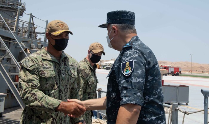 210812-N-WQ732-1016 BERENICE, Egypt (August 12, 2021) – Capt. Joseph Baggett, commanding officer of guided-missile cruiser USS Monterey (CG 61), left, greets Vice Adm. Ahmed Khaled Hassan Saeed, commander of the Egyptian Naval Force, during a tour of the ship in Berenice, Egypt, Aug. 12. Monterey is deployed to the U.S. 5th Fleet area of operations in support of naval operations to ensure maritime stability and security in the Central Region, connecting the Mediterranean and Pacific through the western Indian Ocean and three strategic choke points. (U.S. Navy photo by Mass Communication Specialist Seaman Chelsea Palmer)