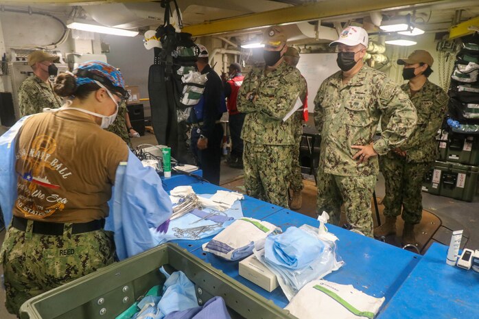 NAVAL STATION NORFOLK (Aug. 14, 2021) – Rear Adm. Darin Via, commander, Naval Medical Forces Atlantic, right, observes members of Fleet Surgical Team 4 in the operating room aboard the dock landing ship USS Whidbey Island (LSD 41), the lead ship of its class of the same name, during a mass casualty drill in support of Large Scale Exercise (LSE) 2021. LSE 2021 demonstrates the Navy's ability to employ precise, lethal, and overwhelming force globally across three naval component commands, five numbered fleets, and 17 time zones. (U.S. Navy photo by Ens. Drew Hendricks)