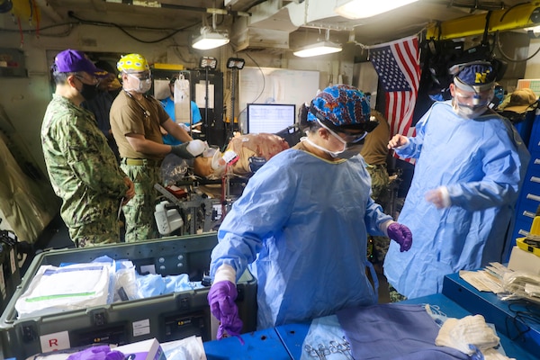 NAVAL STATION NORFOLK (Aug. 14, 2021) –Members of Fleet Surgical Team 4 begin surgery on a simulated crash victim during a mass casualty drill aboard the dock landing ship USS Whidbey Island (LSD 41), the lead ship of its class of the same name, in support of Large Scale Exercise (LSE) 2021. LSE 2021 demonstrates the Navy's ability to employ precise, lethal, and overwhelming force globally across three naval component commands, five numbered fleets, and 17 time zones. (U.S. Navy photo by Ens. Drew Hendricks)