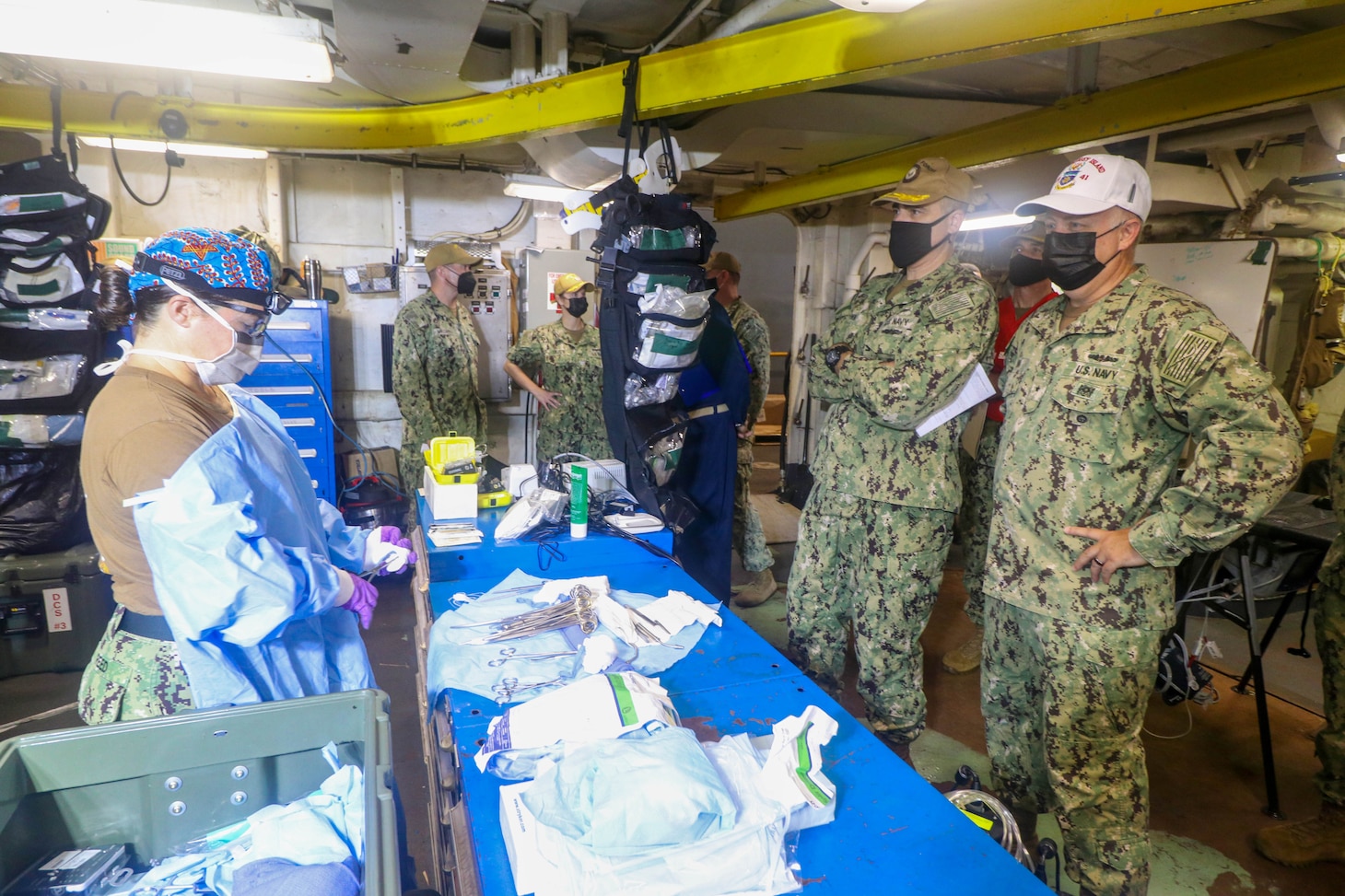NAVAL STATION NORFOLK (Aug. 14, 2021) – Rear Adm. Darin Via, commander, Naval Medical Forces Atlantic, right, observes members of Fleet Surgical Team 4 in the operating room aboard the dock landing ship USS Whidbey Island (LSD 41), the lead ship of its class of the same name, during a mass casualty drill in support of Large Scale Exercise (LSE) 2021. LSE 2021 demonstrates the Navy's ability to employ precise, lethal, and overwhelming force globally across three naval component commands, five numbered fleets, and 17 time zones. (U.S. Navy photo by Ens. Drew Hendricks)