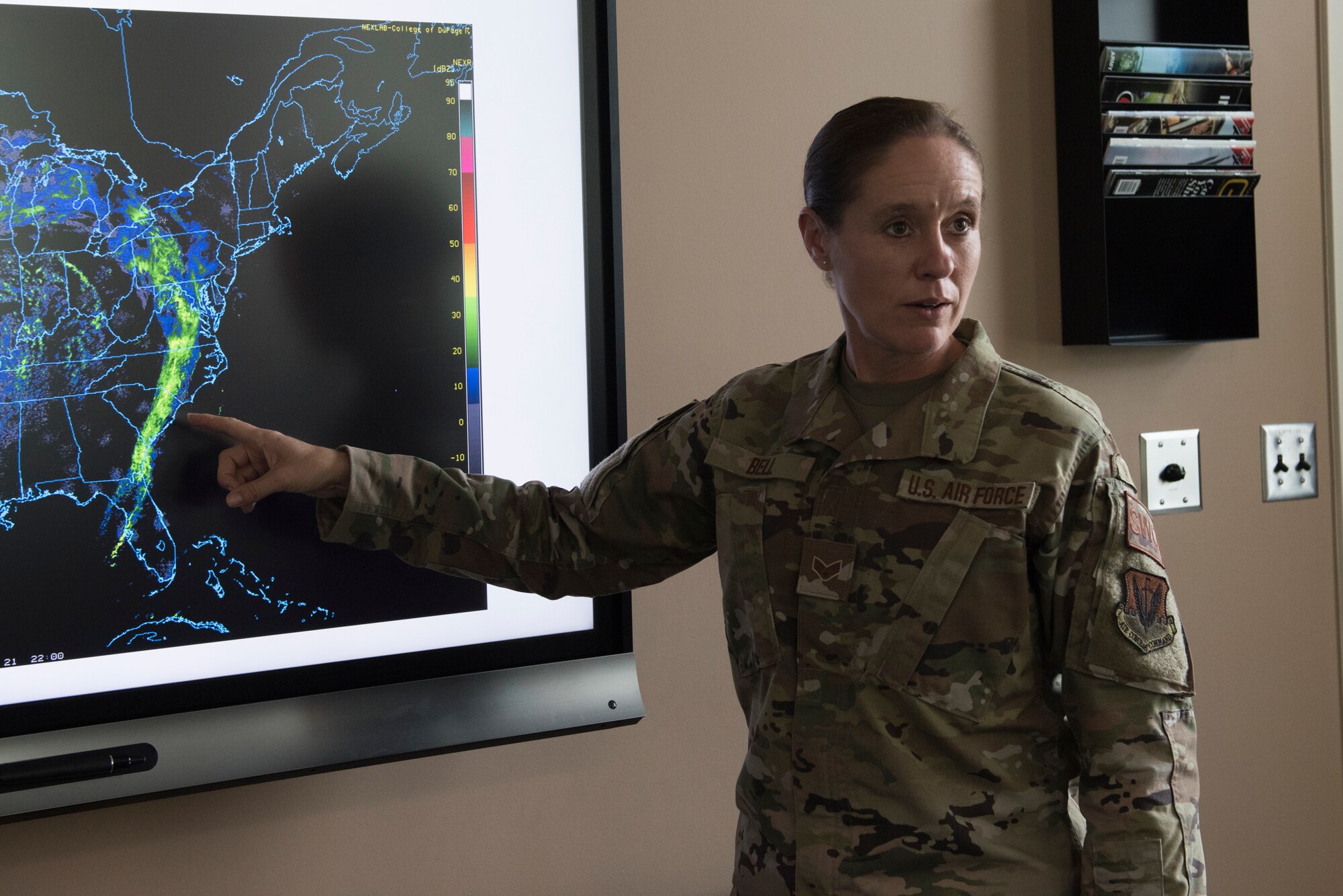 U.S. Air Force Senior Airman Ruth-Ann Bell, a weather forecaster from the 203rd Weather Flight, 193rd Special Operations Wing, Pennsylvania National Guard, presents a weather forecast August 6, 2021 at Fort Indiantown Gap, Annville, Pennsylvania. Bell was chosen as the ANG’s Outstanding Airman of the Year 2020. (U.S. Air National Guard photo by MSgt Matt Schwartz)
