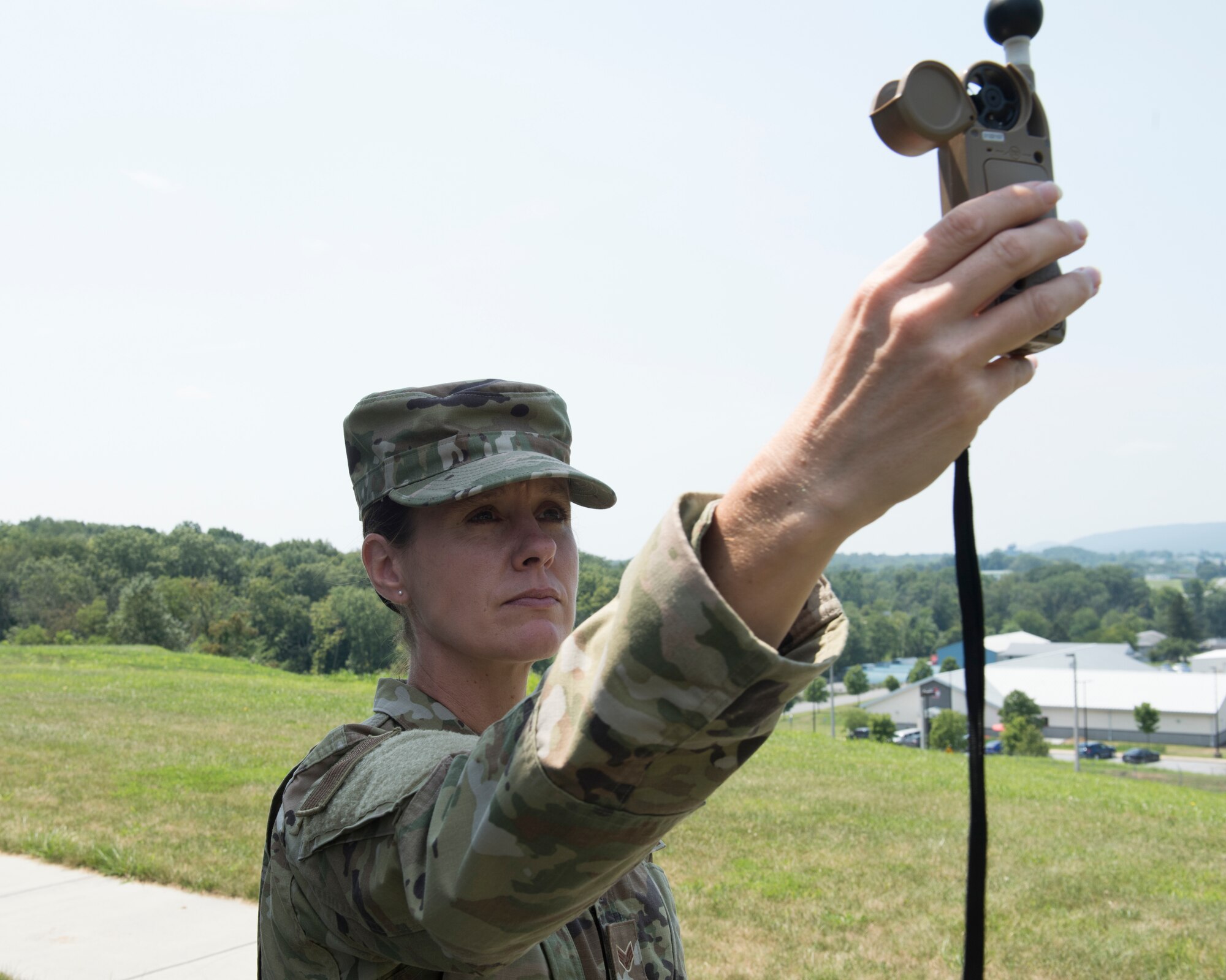 U.S. Air Force Senior Airman Ruth-Ann Bell, a weather forecaster from the 203rd Weather Flight, 193rd Special Operations Wing, Pennsylvania Air National Guard uses her Kestrel Heat Stress Tracker August 6, 2021 at Fort Indiantown Gap, Annville, Pennsylvania. Bell was chosen as the ANG’s Outstanding Airman of the Year 2020. (U.S. Air National Guard photo by MSgt Matt Schwartz)