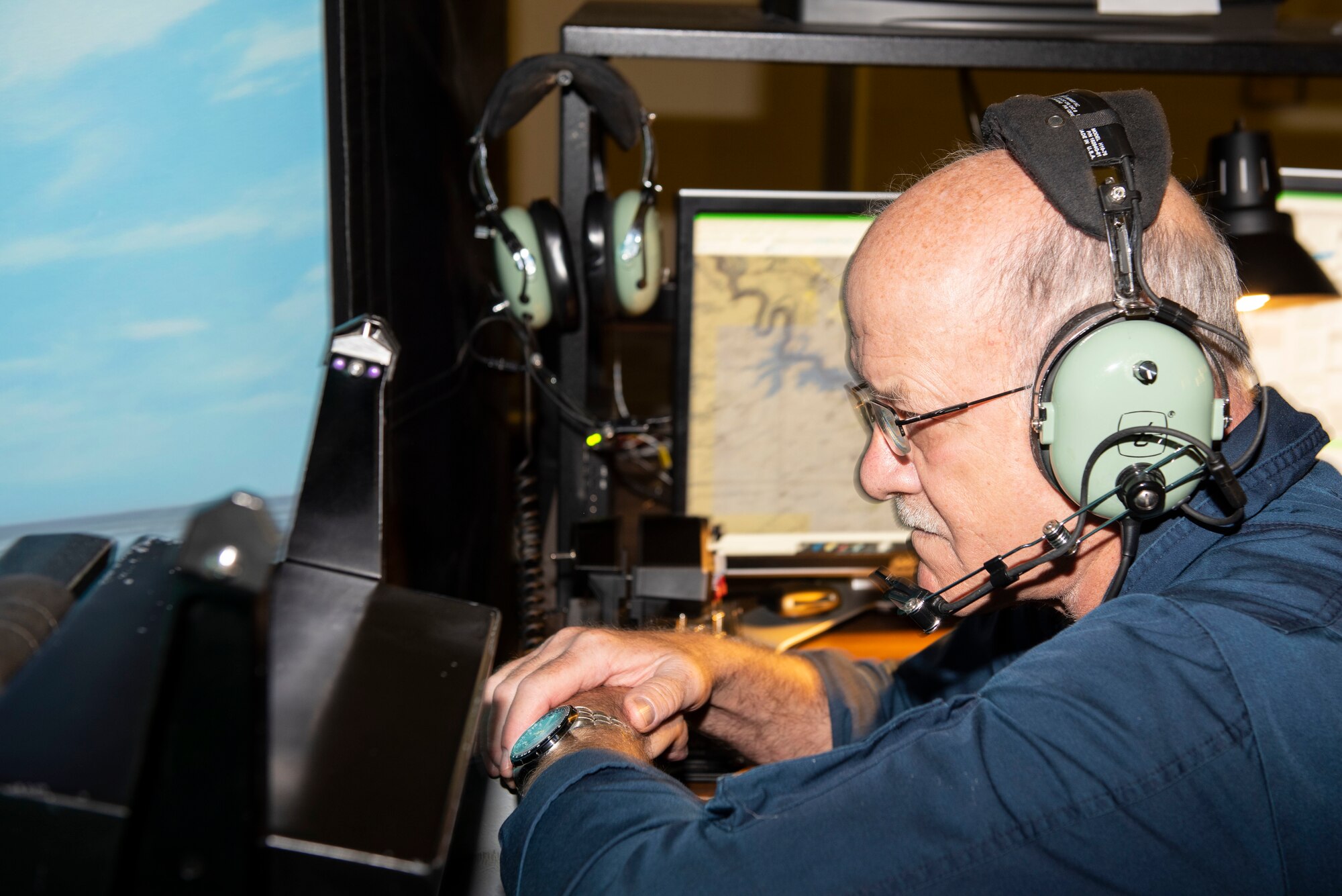 Tom Kline, 47th Operations Group T-38 lead instructor, monitors the controls of a student’s simulated flight at Laughlin Air Force Base, Texas on Jul. 19, 2021. The simulators are state of the art equipment that can replicate any environment or situation that they may face when piloting the aircraft. (U.S. Air Force photo by Airman 1st Class David Phaff)