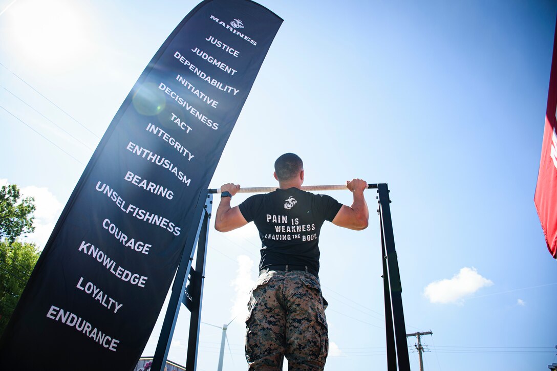 U.S. Marine Staff Sgt. Jorden MacIntyre, a recruiter with Recruiting Station Cleveland, executes a pull-up as a demonstration at the Cuyahoga County Fair, at Middleburg Heights, Ohio, Aug. 14, 2021. The purpose of the event was for recruiters to engage with the local community and to invite civilians to participate in a pull-up challenge to earn Marine Corps Prizes. (U.S. Marine Corps photo by Cpl. Nello Miele)