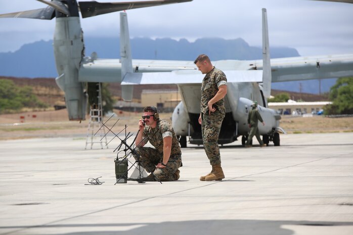 Cpl. Brooks Woodhill, a transmissions systems operator, and Staff Sgt. Thomas King, a transmissions chief, both of 3rd Marine Regiment, use the Mobile User Objective System during Island Marauder 2021 Aug. 11 at Marine Corps Base Hawaii. Island Marauder is an annual, Marine Corps Systems Command-led exercise enabling Marines to assess and familiarize themselves with communications gear. This year’s exercise was nested under the Navy’s Large Scale Exercise. (U.S. Marine Corps photo by Ashley Calingo)