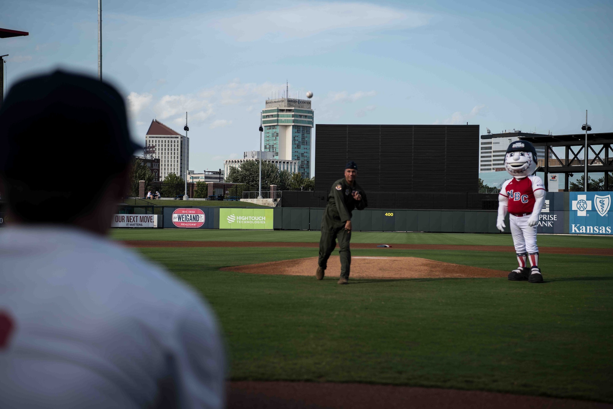 Col. Nate Vogel, 22nd Air Refueling Wing commander, throws the first pitch at a National Baseball Congress World Series ball game, Aug. 19, 2021, in Wichita, Kansas. Vogel was invited to throw the first pitch as a guest for Armed Forces Appreciation Night at Riverfront Stadium. (U.S. Air Force photo by Senior Airman Marc A. Garcia)