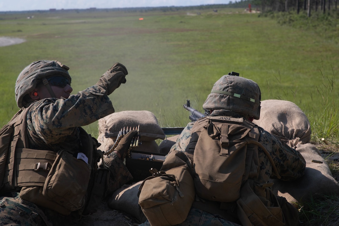 U.S. Marine Corps Lance Cpl. Samal Khosravi, left, and Lance Cpl. Matthew Jude, both machine gunners with 3d Battalion, 2d Marine Regiment, 2d Marine Division, suppress notional enemies during a support-by-fire range as part of a field exercise on Camp Lejeune, N.C., Aug. 12, 2021. The  focus of this exercise was to prepare for their next evolution of training as the unit works toward future deployments. (U.S. Marine Corps photo by Lance Cpl. Reine Whitaker)