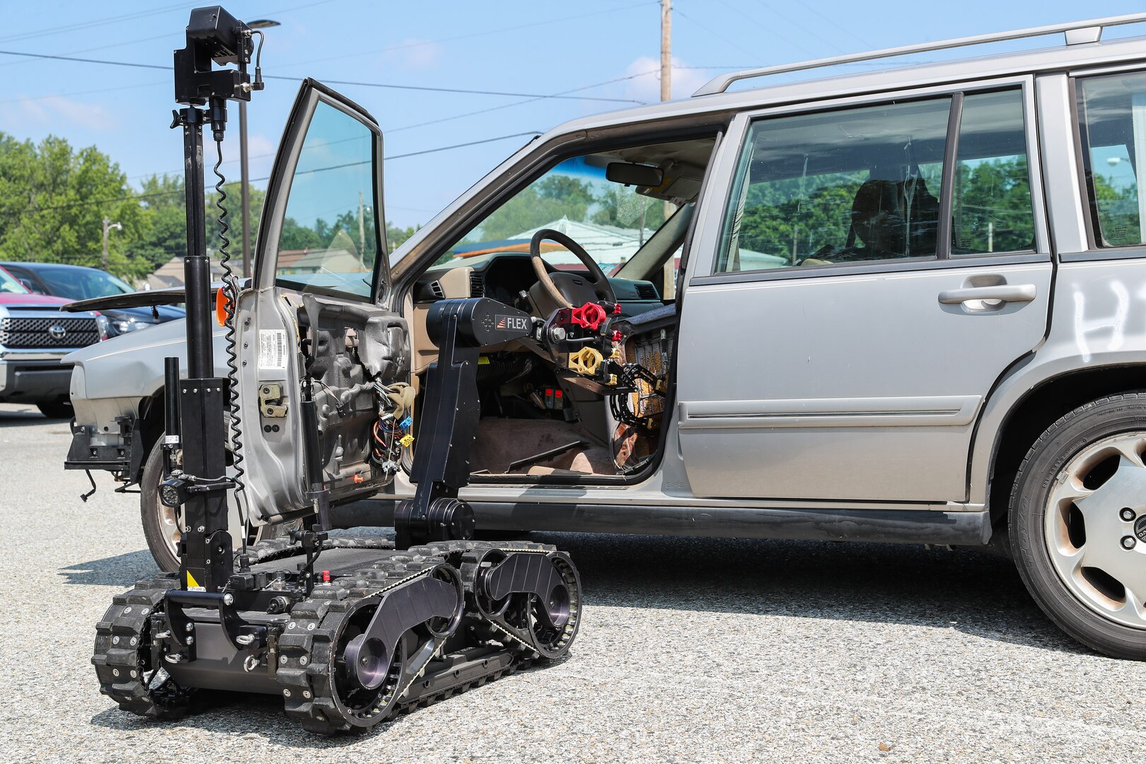 Operators at the 2021 Eastern National Robot Rodeo held in Indian Head, Maryland, use a robot to search an abandoned car after opening the car door with the robot’s arm, Aug. 2.