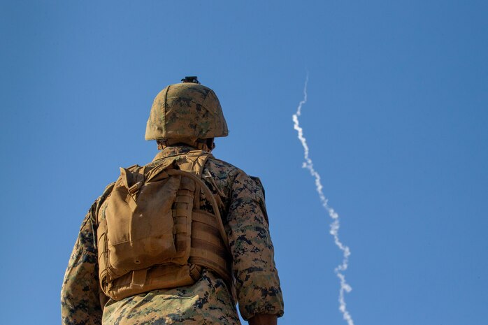 U.S. Marine Corps Lance Cpl. Dantrel Gandy, a Low Altitude Air Defense gunner with Alpha Battery, 2nd LAAD Platoon, Marine Medium Tilt Rotor Squadron – 363 (Reinforced), with Marine Rotational Force – Darwin, observes a High Mobility Artillery Rocket System launch during Exercise Loobye at Bradshaw Field Training Area, NT, Australia, Aug. 12, 2021. The HIMARS launched as part of the final act of Exercise Loobye to demonstrate MRF-D’s ability to conduct HIMARS Rapid Infiltration. Exercises like Loobye demonstrate MRF-D’s ability to conduct operations as a joint force with the ADF, execute expeditionary operations, like HIRAIN, and exemplify their mutual dedication to being postured and ready to respond to a crisis or contingency in the Indo-Pacific region.