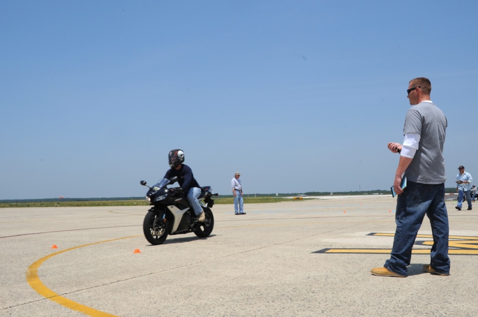 Chief Petty Officer Paul Greenwood, Electronics Support Detachment Atlantic City, N.J., times Senior Airman Charles Zingrone, member of the 177th Fighter Wing New Jersey Air National Guard, during his motorcycle safety course at Coast Guard Air Station Atlantic City June 8, 2011. Greenwood is one of four Coast Guard members trained to conduct the course for active duty members, their dependants and retirees. U.S. Coast Guard photo by Petty Officer 2nd Class Crystalynn A. Kneen.